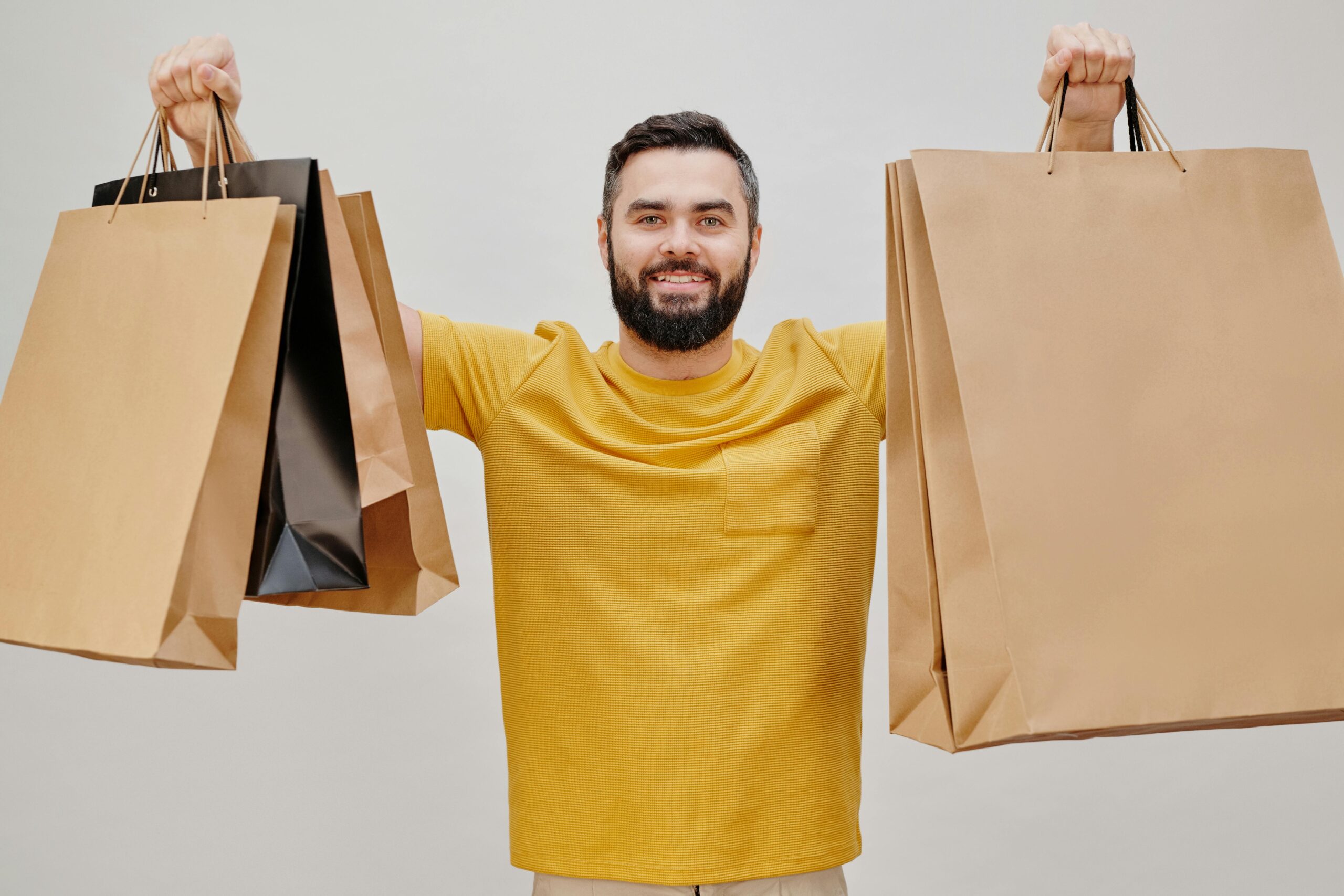 Man in Yellow Crew Neck T-shirt Holding Brown Paper Bags